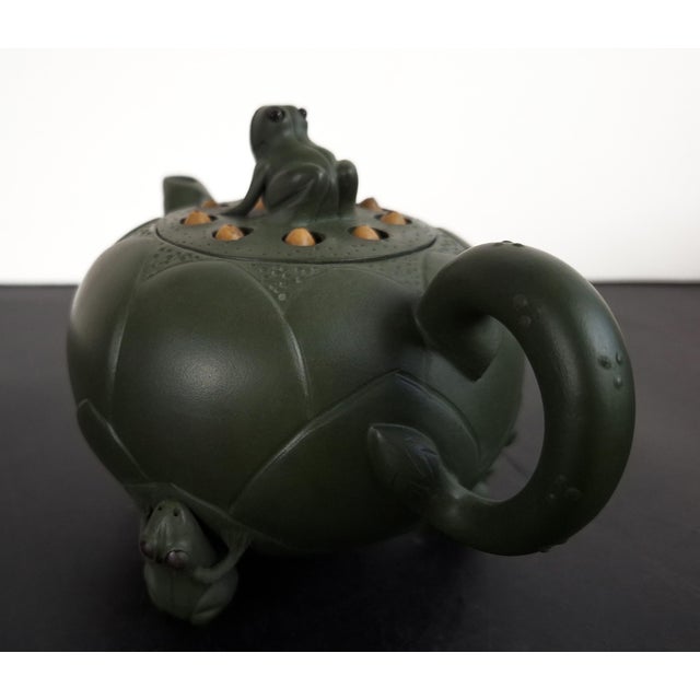 Chinese Yixing Zisha lotus flower frogs teapot, a finely formed, olive green, teapot in the shape of a lotus flower with a...