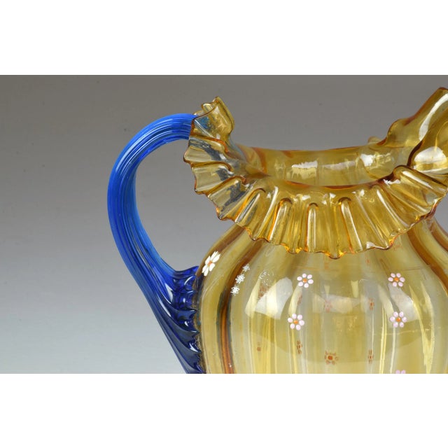 Murano glass pitcher in a Liberty-inspired vocabulary, worked in blue and yellow with floral decoration, optic ribs and...