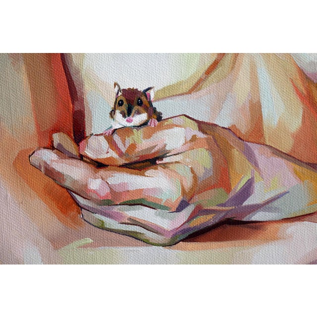 The artwork depicts a figure with gently crossed arms, cradling a small creature in the left hand, creating an intimate...