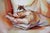 The artwork depicts a figure with gently crossed arms, cradling a small creature in the left hand, creating an intimate...