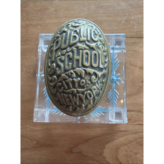 Offered here is an authentic antique cast brass door knob from a Public School in the City of New York. One little leg is...