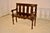 19th century French oak settee with hand carving. The back is carved and has a molded edge over three vase shaped carved...