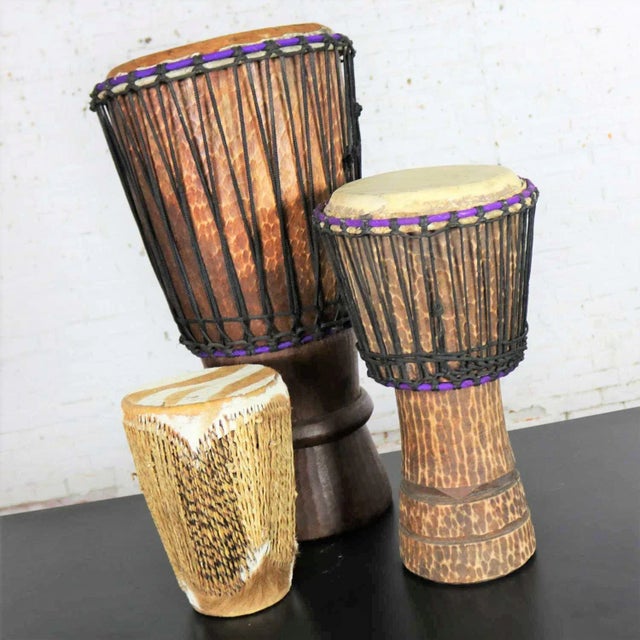 Intriguing trio of differing size tribal drums of carved wood and animal hide. They are in wonderful condition. Priced as...