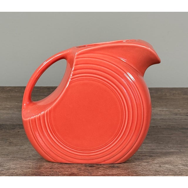 Vintage Fiesta Ware ceramic disc pitcher by Homer Laughlin, produced in the United States and marked on the underside....