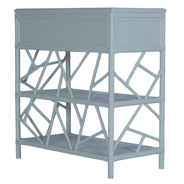 In a whimsical, geometric pattern, this beautiful and functional end table is constructed with a Rattan frame and rawhide...