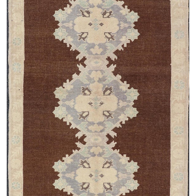 This vintage Turkish Oushak gallery rug (circa mid-20th century) features a unique blend of colors and an intricately...
