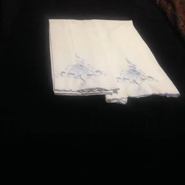 Two vintage white and blue embroidered pillowcases. Very soft cotton, has some small tears and small stains.