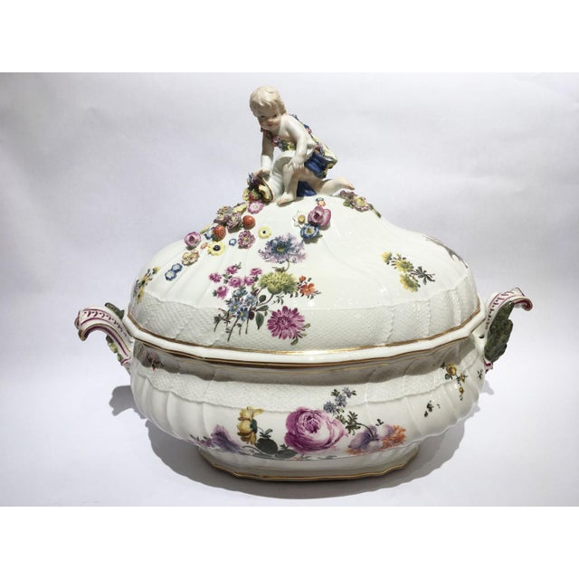 This is a spectacular lidded tureen made by Meissen circa 1755. The white porcelain is decorated with multicolored flower...