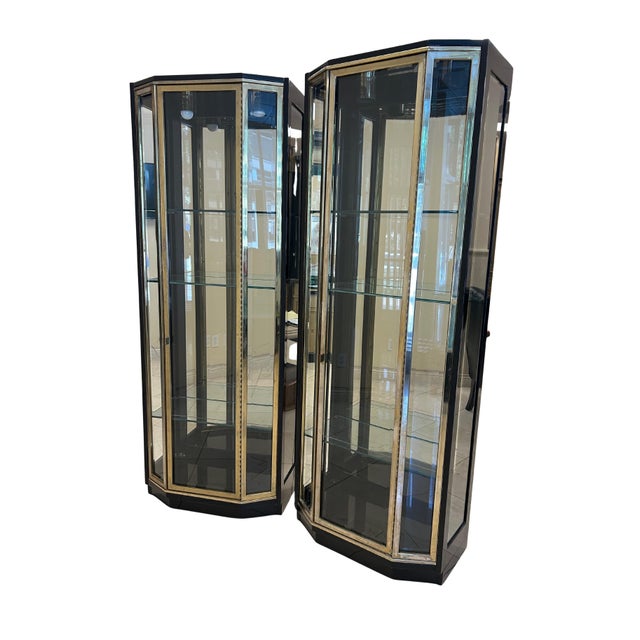 This impressive three-piece black lacquer and brass display cabinet set exemplifies the luxurious, architectural styling...