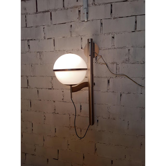 Pusicona wall lamp with opaline glass globe and height-adjustable chrome. Produced by Artemide, designed by Franco...