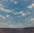 Dancing Clouds captures a serene sky filled with dynamic, swirling clouds that evoke a sense of movement and tranquility....