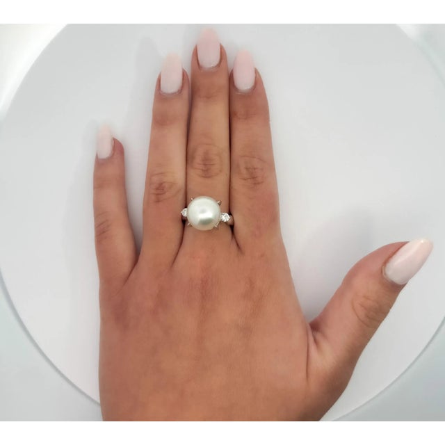 Natural Pearl and Diamond Platinum 900 Three Stone Ring. Three stone ring featuring a prominent 12.5-mm pearl center...