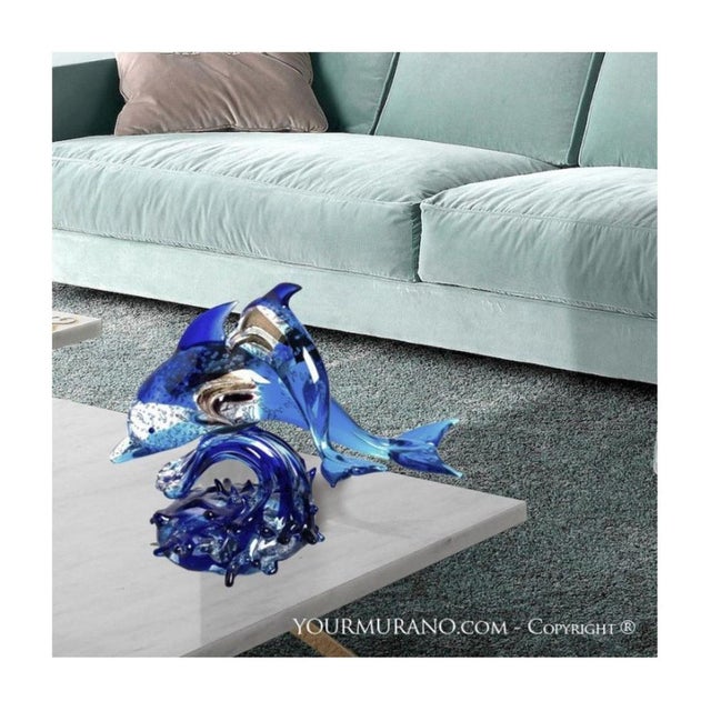 Pair of dolphins in blue Murano glass decorated with bubbles and gold leaf. This creation is a precious decoration that...