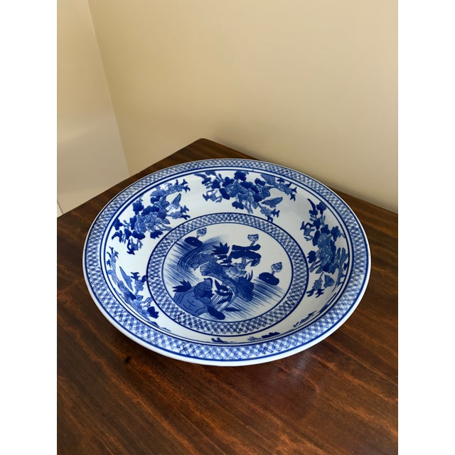 A gorgeous large Chinoiserie blue and white porcelain shallow bowl, planter, or decorative charge plate featuring birds...