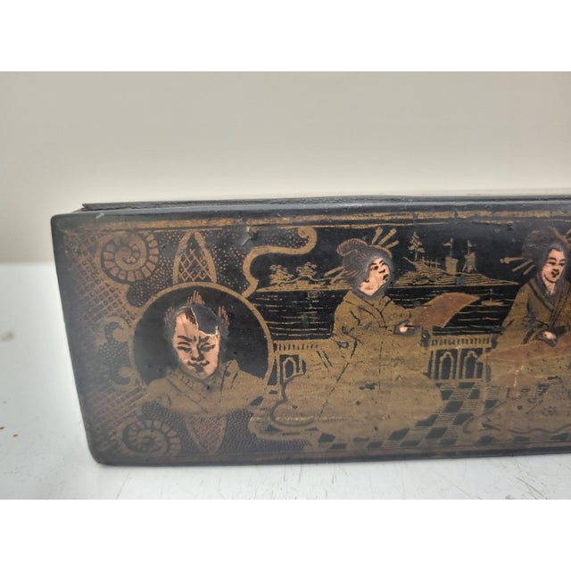 Beautiful antique Chinese calligraphy box. Black lacquered wood with elaborate gilt figural design. Hinged lid opens to 3...