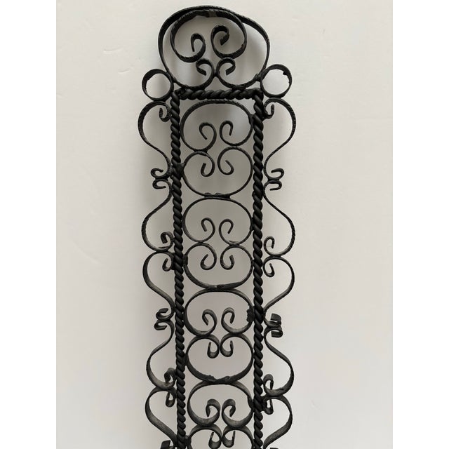 Tall ornate wrought iron wall accent candle holder. Gothic 1960s 1970s vintage wall accent for taper candles.