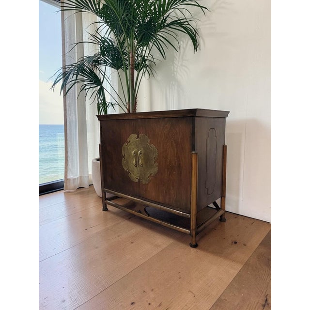 This Ming-style sideboard embodies Mid-Century Chinoiserie, blending the clean architectural lines of 1950s design with...