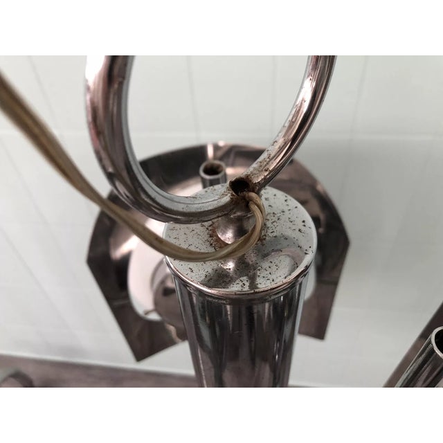 Italian-made chandelier from the 1970s Chromed steel structure and 3 light points made up of glass spheres. Up to 250V...