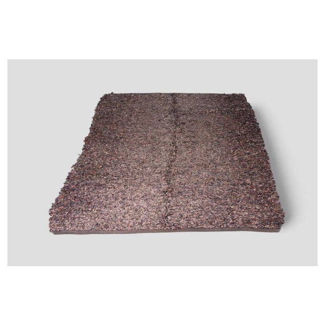 This unique vintage leather and hide rug is perfect for adding character to any room. Crafted from small leather tiles in...