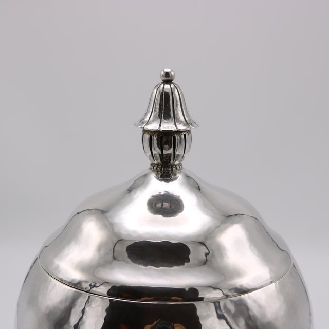 An Art Deco period sterling silver covered vase from Germany circa 1930. The round baluster shape is topped with a lid...