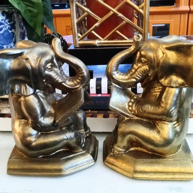 A fun pair of elephants reading a book, bookends. They're such a cute pair and made of metal. No markings.
