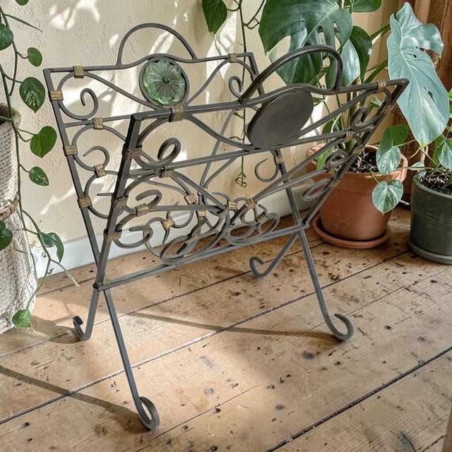 Elevate your home decor with this Folding Magazine or Record Holder, featuring an elegant green glass medallion that adds...