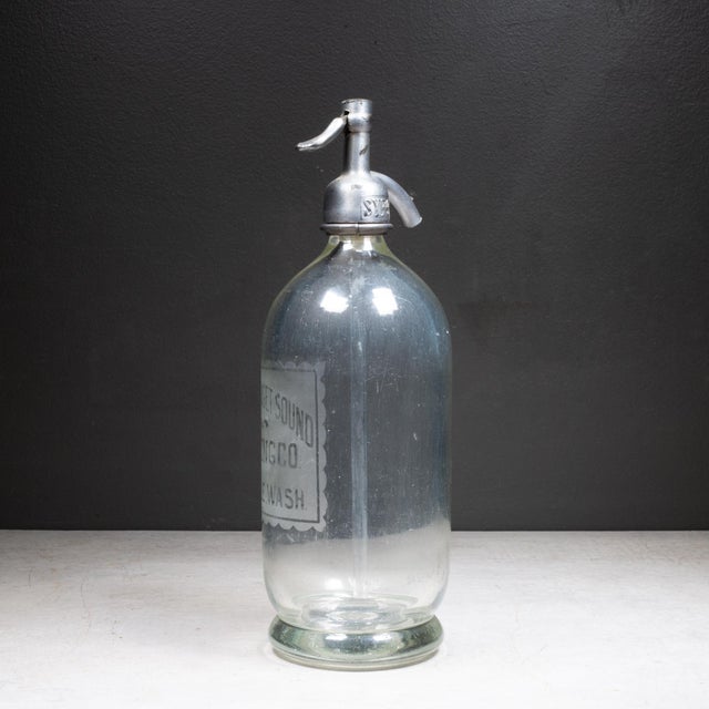 ABOUT Antique heavy glass mineral water seltzer siphon bottle with chrome plated dispensing head. Acid-etched lettering on...