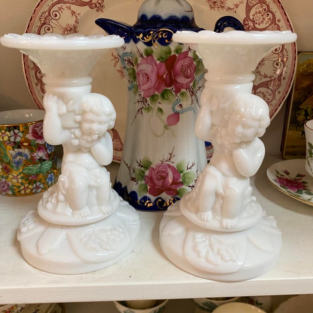 A pair of cherub milk glass candle stick holders. Beautiful pair.