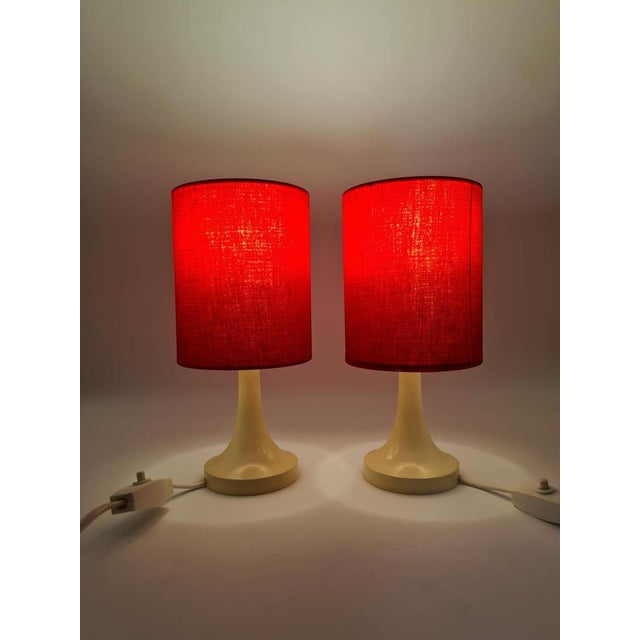 A pair of vintage table lamps in the Mid-Century Modern style, originating from Europe and dating back to the 1960s–1970s....