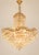 An exceptional and highly decorative monumental crystal chandelier, executed in the glamorous Hollywood Regency style and...
