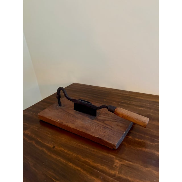A beautiful antique French Country style hand-made wooden herb-cutting board with an iron handle and cutter. This piece...