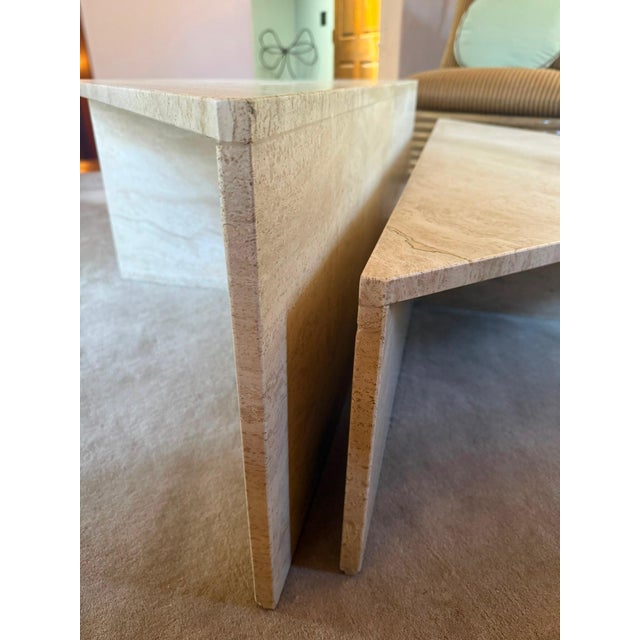 Description: Italian sculptural two-part travertine coffee table from the 1970s, showcasing a beautiful travertine grain...