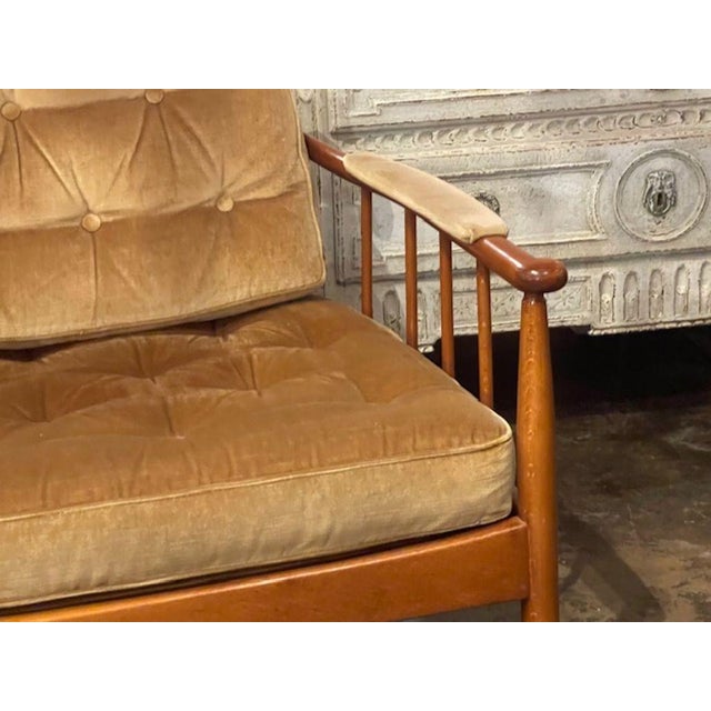 This product is a pair of Danish MCM walnut armchairs. The armchairs feature a sleek and minimalist design typical of the...