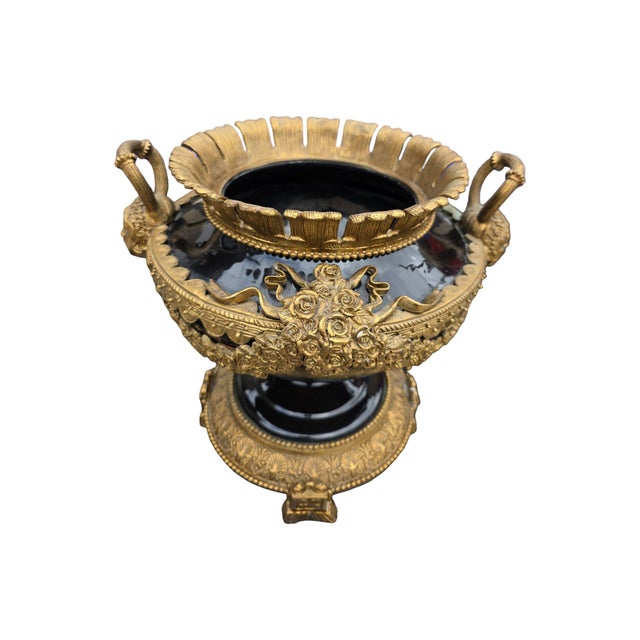 Striking large-scale neoclassical centerpiece urn featuring a dramatic glossy black body with elaborate gilt metal ormolu-...