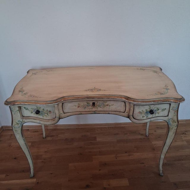 A delicate, heavy lady's writing desk in the french louis xv style. Solid beechwood, hand-painted, with three drawers and...