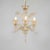 This vintage handcrafted gold-infused cristallo Murano chandelier has three scroll arms with chalice cups, utilizing a...