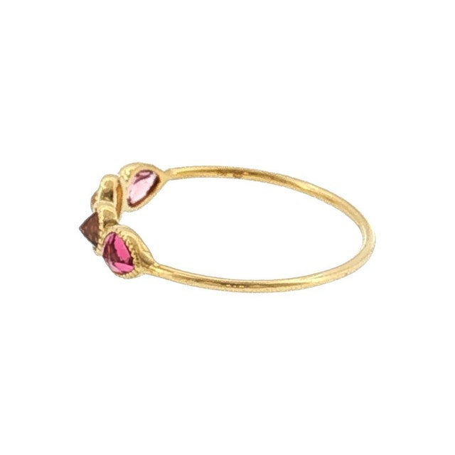 A 21st-century 18k gold ring featuring a series of bezel-set gemstones designed by Perle de Lune. The design includes a...