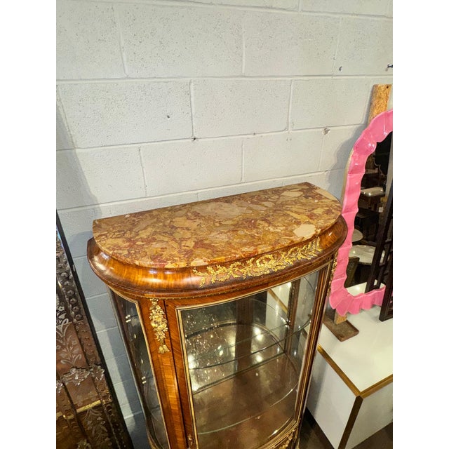 The 19th c. French Louis XVI Linke Manner Vitrine is an antique piece of furniture that exudes elegance and...