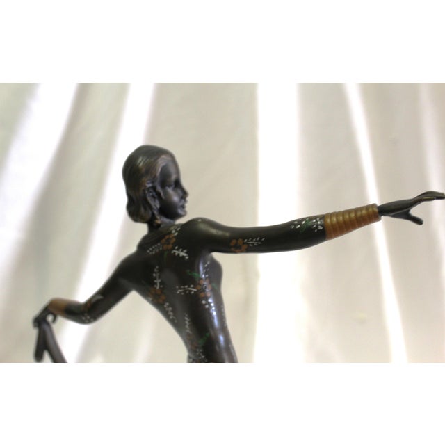A Mid-Century /deco style Bronze Casting of a deco dancer holding her skirt up in hi-details with hand finished . She is...