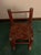 Unknown age child’s rocking chair in reddish brown with green accents in a farmhouse or cottagecore style. It measures...