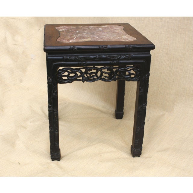 Antique early 20th Century Chinese carved redwood pink marble top table. Square top with a flush marble inset; hand-carved...