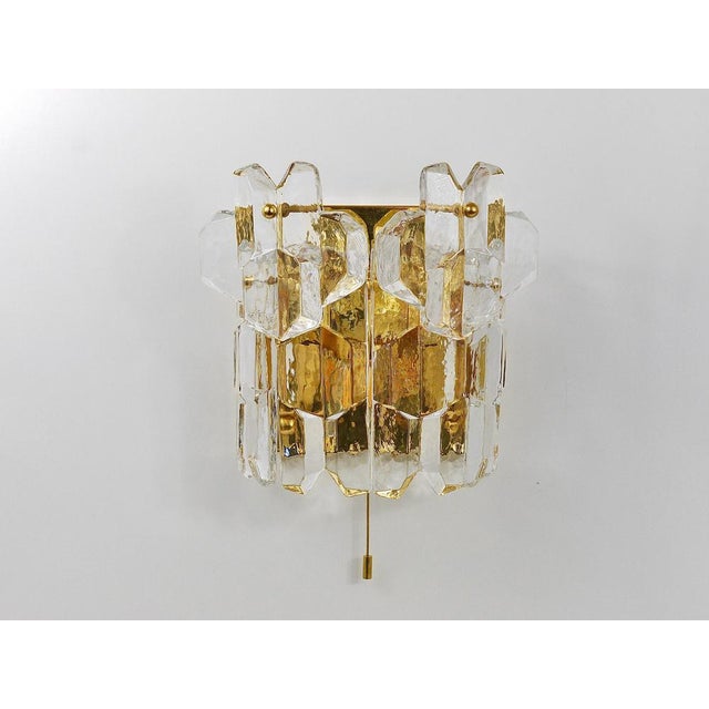 An elegant and large handmade wall light, produced by Kalmar Franken KG in the 1970s. Its frame is made of gold-plated...