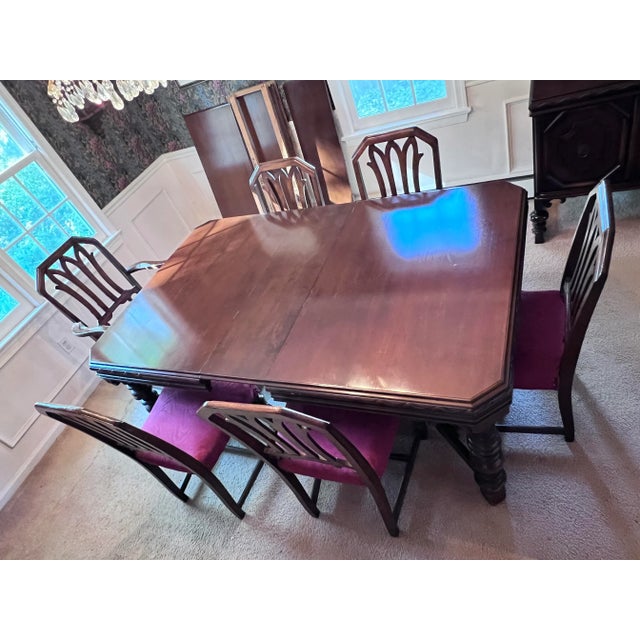 Early 20th century Jacobean Revival mahogany-veneer dining table with six chairs, including one Captain's chair. Table at...