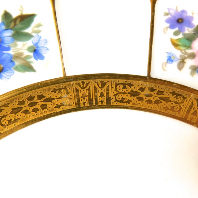 This is a lot of six white floral Rosenthal Dinner plate from Gimbles of New York. It has a gold encrusted band at the...