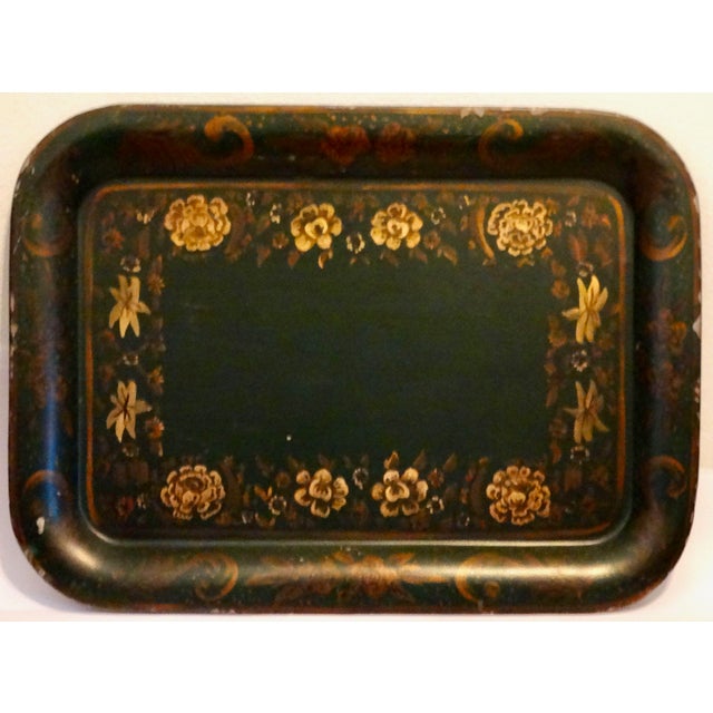 Large Mid Century tole tray hand painted with a gold floral design on a dark green ground. This statement size tray would...