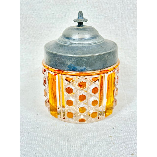 Lovely vintage clear and amber cut glass lidded container. The top is pewter. Intricate cut glass design. Perfect to use...