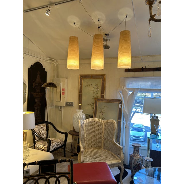 Warm striated gold and cream fiberglass pendants from Italy. Can take up to 150 watts per fixture. Opening at top is 6.25