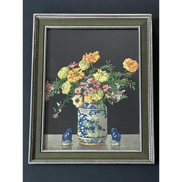 Framed vintage art print from the mid 20th century features a superb still life of colorful flowers in a painted ceramic...