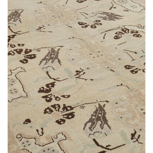 This vintage handwoven Turkish rug has a beige cream field with sprays of lozenges issuing floral motif, enclosing five...