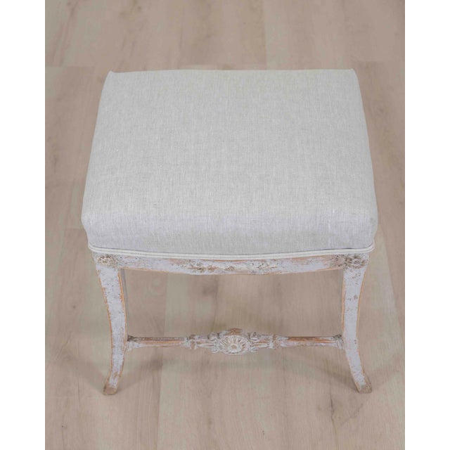 Made in Sweden around 1810, this Gustavian stool shows the restrained neoclassical character of the style. The Gustavian...